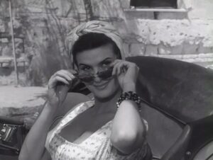 Photo of Irene Tunc wearing Italian sunglasses while starring in the 1957 Italian film Lazzarella